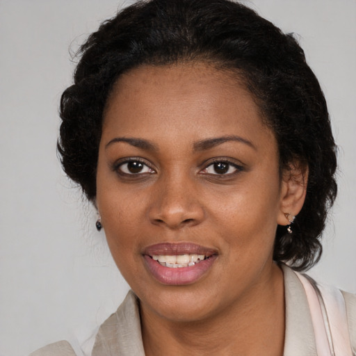 Joyful black young-adult female with medium  brown hair and brown eyes