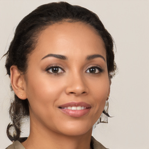 Joyful latino young-adult female with long  brown hair and brown eyes