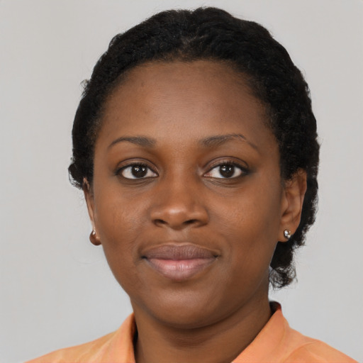 Joyful latino young-adult female with short  black hair and brown eyes