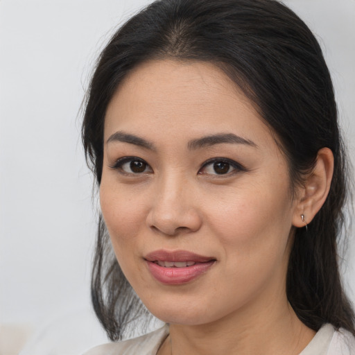 Joyful asian young-adult female with medium  brown hair and brown eyes