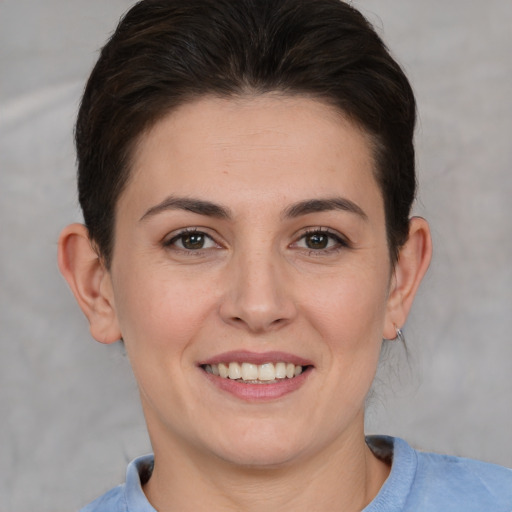 Joyful white young-adult female with short  brown hair and brown eyes