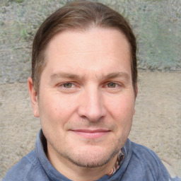 Joyful white adult male with short  brown hair and grey eyes