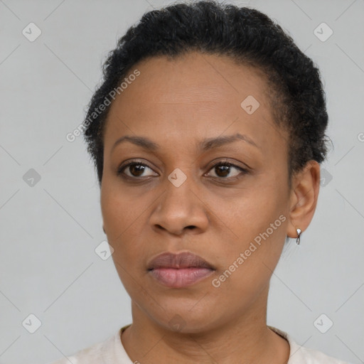 Joyful black adult female with short  brown hair and brown eyes