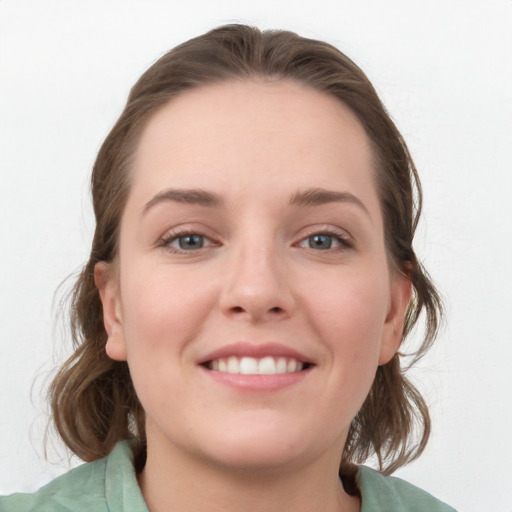 Joyful white young-adult female with medium  brown hair and blue eyes