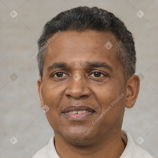 Joyful black adult male with short  black hair and brown eyes