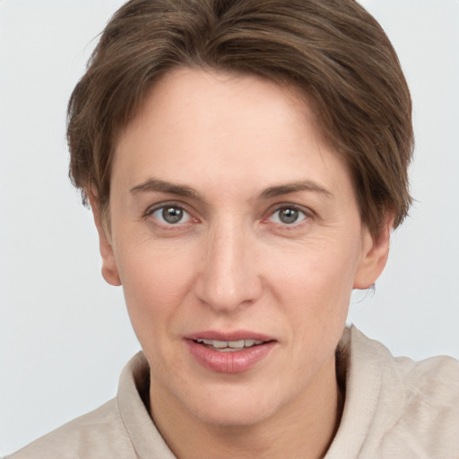 Joyful white adult female with short  brown hair and grey eyes