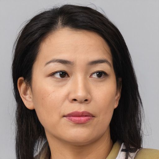 Joyful asian adult female with medium  brown hair and brown eyes