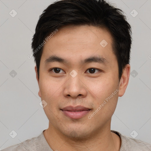 Joyful asian young-adult male with short  brown hair and brown eyes