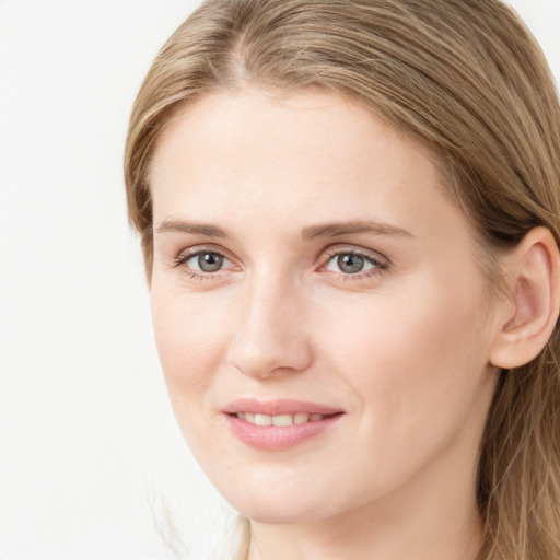 Joyful white young-adult female with long  brown hair and blue eyes