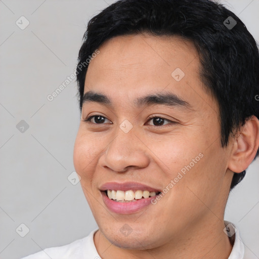 Joyful latino young-adult male with short  black hair and brown eyes