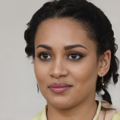 Joyful black young-adult female with medium  black hair and brown eyes