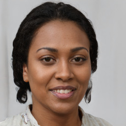 Joyful black young-adult female with medium  brown hair and brown eyes