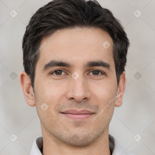 Joyful white young-adult male with short  black hair and brown eyes