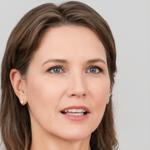 Joyful white young-adult female with long  brown hair and grey eyes