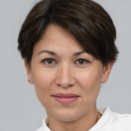 Joyful white adult female with short  brown hair and brown eyes