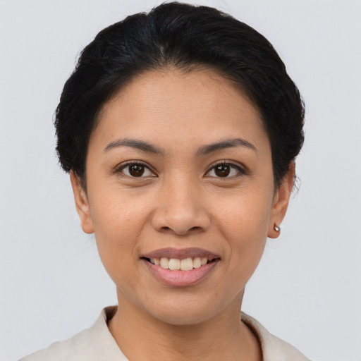 Joyful asian young-adult female with short  brown hair and brown eyes