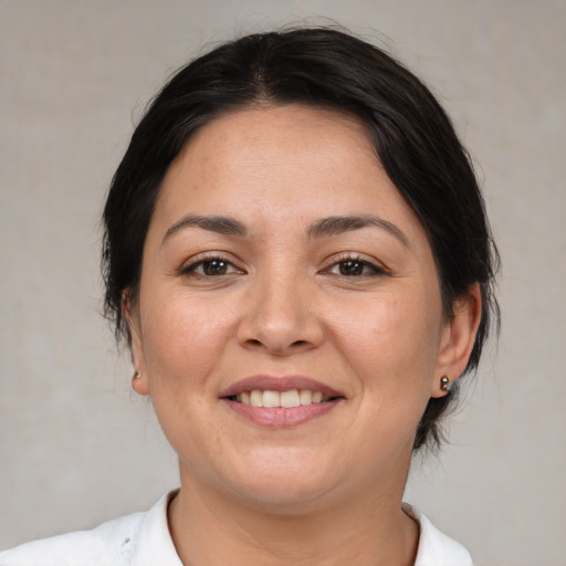 Joyful white adult female with medium  brown hair and brown eyes