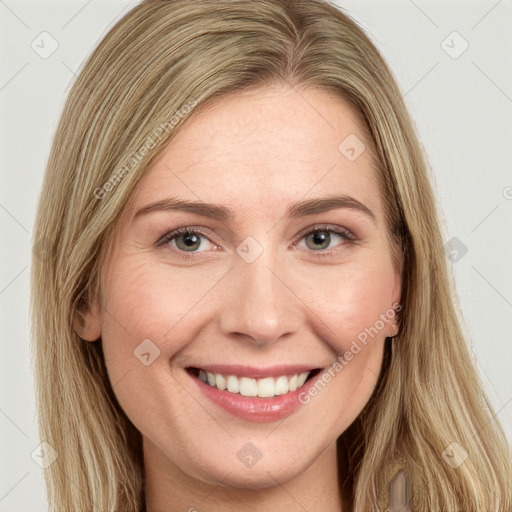 Joyful white young-adult female with long  brown hair and green eyes