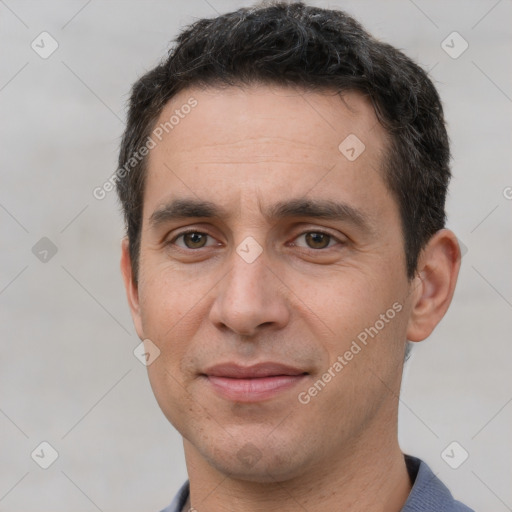 Joyful white adult male with short  brown hair and brown eyes