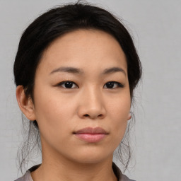 Joyful asian young-adult female with medium  black hair and brown eyes