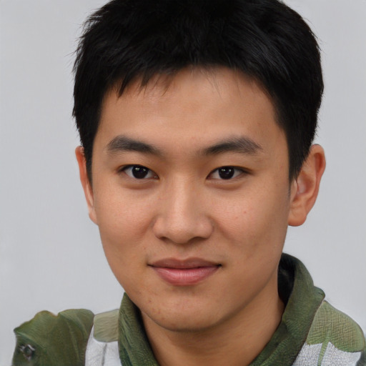 Joyful asian young-adult male with short  brown hair and brown eyes