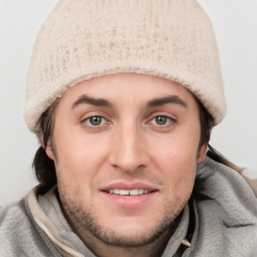 Joyful white young-adult male with short  brown hair and grey eyes