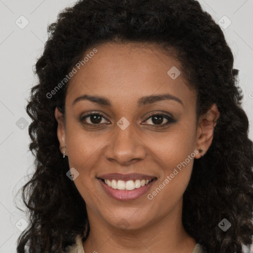 Joyful black young-adult female with long  brown hair and brown eyes