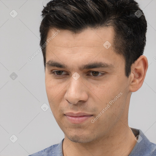 Joyful white young-adult male with short  black hair and brown eyes