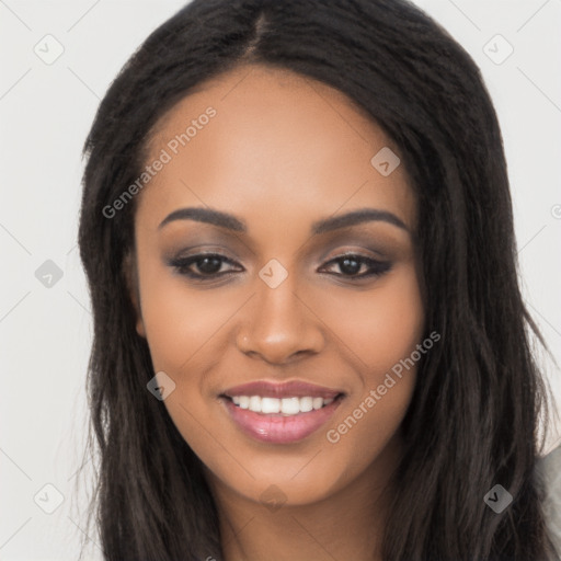 Joyful black young-adult female with long  black hair and brown eyes