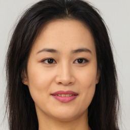 Joyful asian young-adult female with long  brown hair and brown eyes