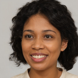 Joyful black young-adult female with medium  brown hair and brown eyes