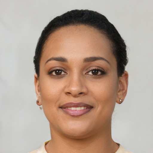 Joyful latino young-adult female with short  brown hair and brown eyes