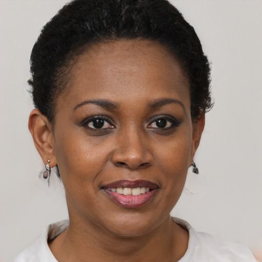 Joyful black young-adult female with short  brown hair and brown eyes