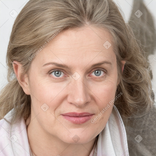 Joyful white adult female with medium  brown hair and blue eyes