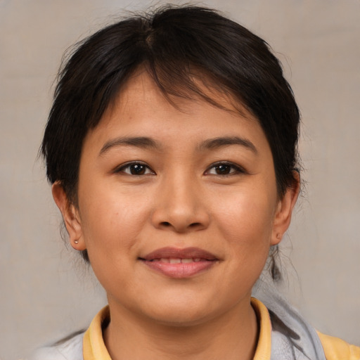 Joyful asian young-adult female with medium  brown hair and brown eyes