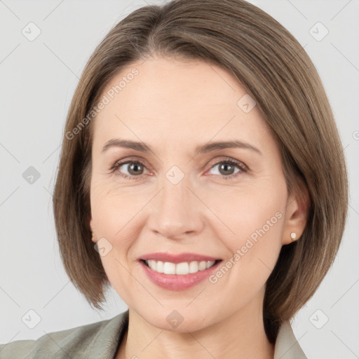 Joyful white adult female with medium  brown hair and grey eyes