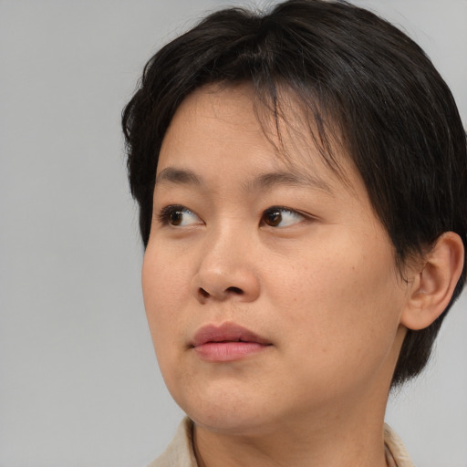 Neutral asian young-adult female with medium  brown hair and brown eyes