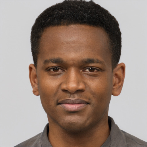 Joyful latino young-adult male with short  brown hair and brown eyes