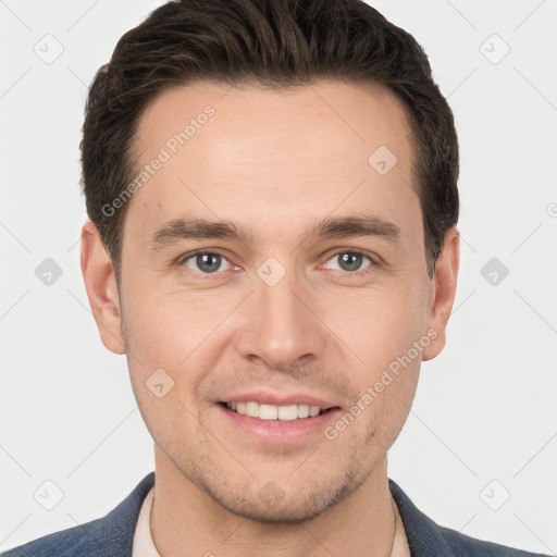 Joyful white young-adult male with short  brown hair and grey eyes