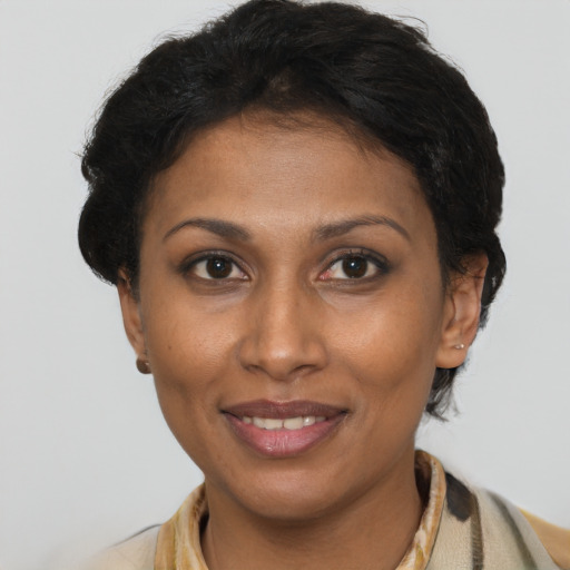 Joyful black adult female with short  brown hair and brown eyes