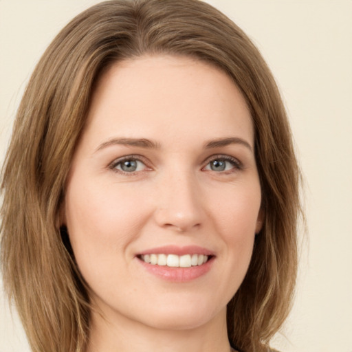 Joyful white young-adult female with long  brown hair and green eyes