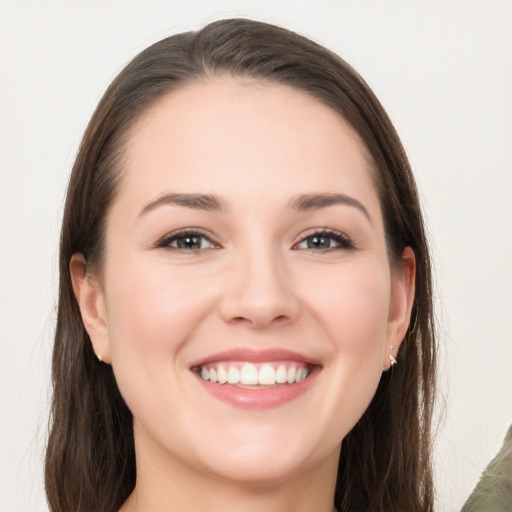 Joyful white young-adult female with long  brown hair and grey eyes