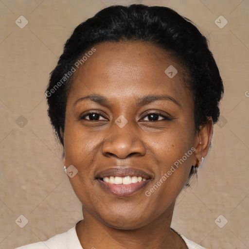 Joyful black young-adult female with short  black hair and brown eyes