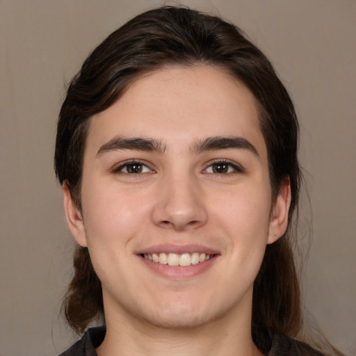 Joyful white young-adult male with medium  brown hair and brown eyes