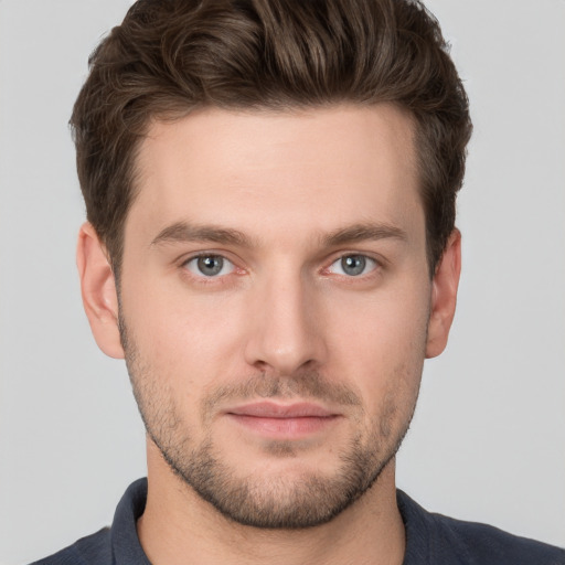 Joyful white young-adult male with short  brown hair and grey eyes