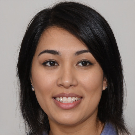 Joyful latino young-adult female with long  black hair and brown eyes