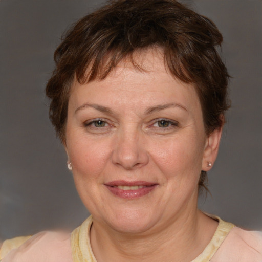 Joyful white adult female with short  brown hair and brown eyes