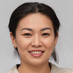 Joyful asian young-adult female with medium  brown hair and brown eyes