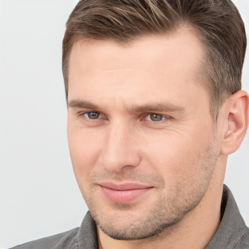 Joyful white adult male with short  brown hair and brown eyes