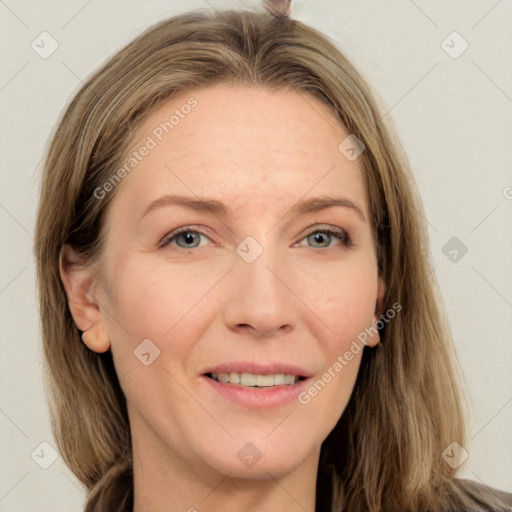 Joyful white adult female with long  brown hair and grey eyes